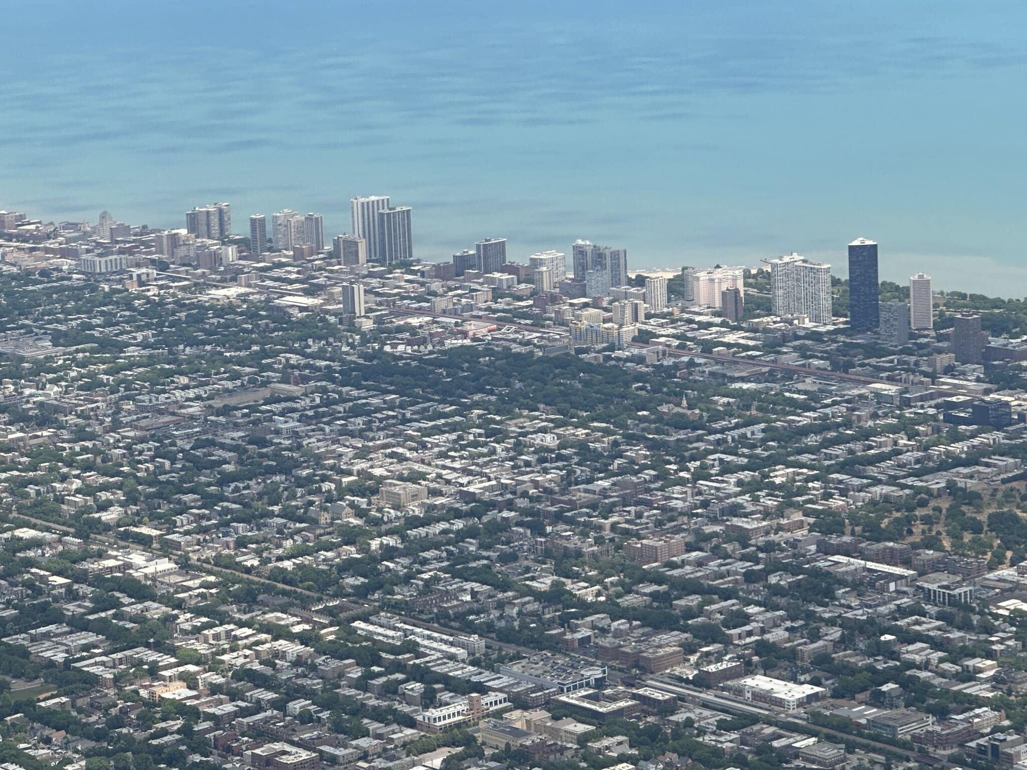 Aerial view of Miami Beach skyline with commercial buildings and ocean backdrop.