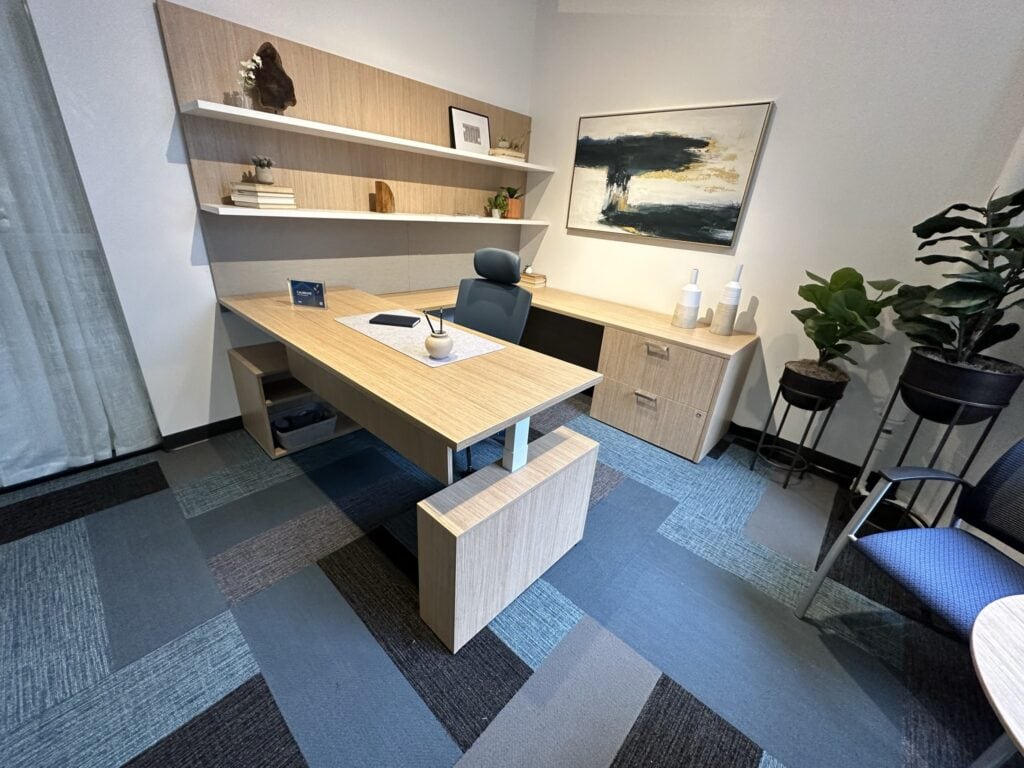 Office workspace with contemporary furniture and artwork for professional environments.