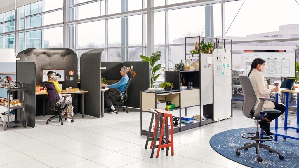 Office workspace with privacy pods and ergonomic chairs for focused work.