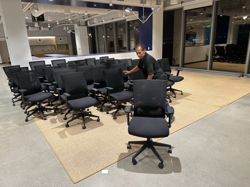 Office conference room with ergonomic chairs and large windows for meetings.