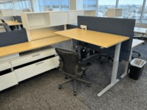 Modern office cubicle workspace with desk and chair setup.