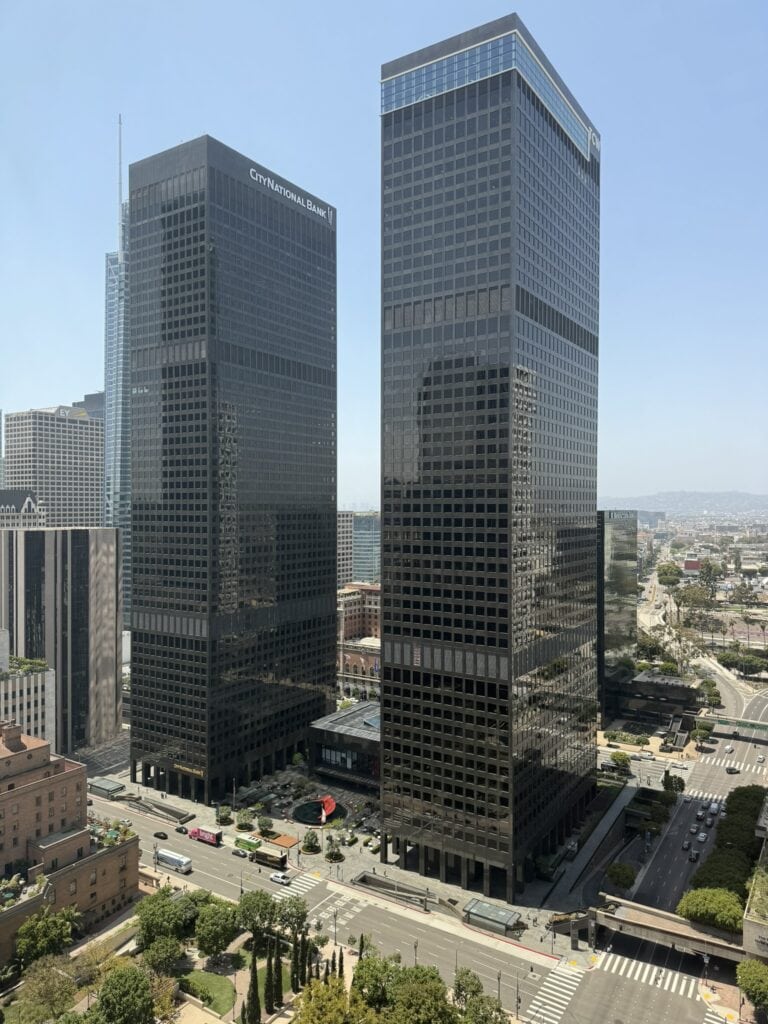 Rise buildings with glass facades in a cityscape.