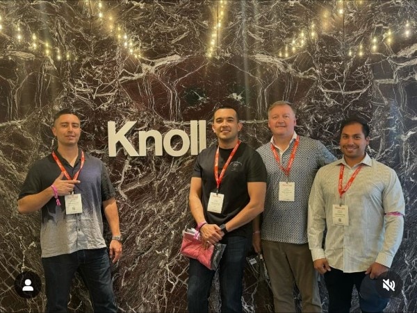 Knoll booth with four professionals showcasing modern workspace solutions.
