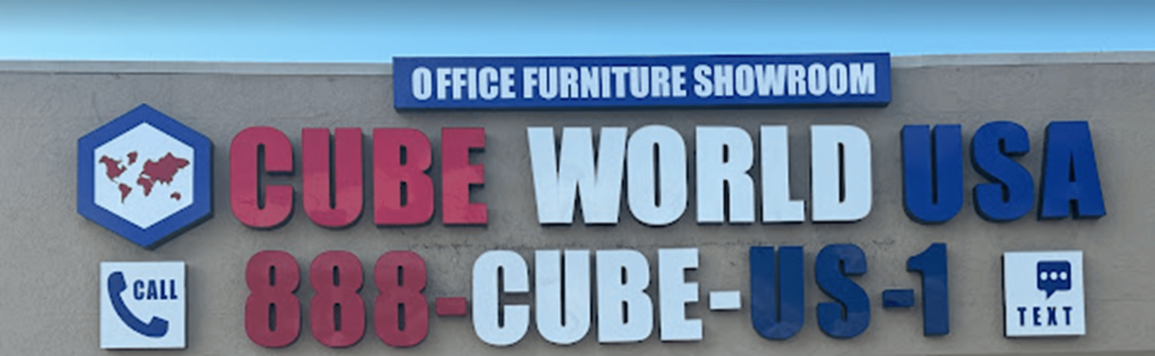 Office furniture showroom sign for Cube World USA with contact info.