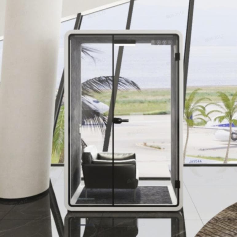 Contemporary glass phone booth with sleek design and scenic view.