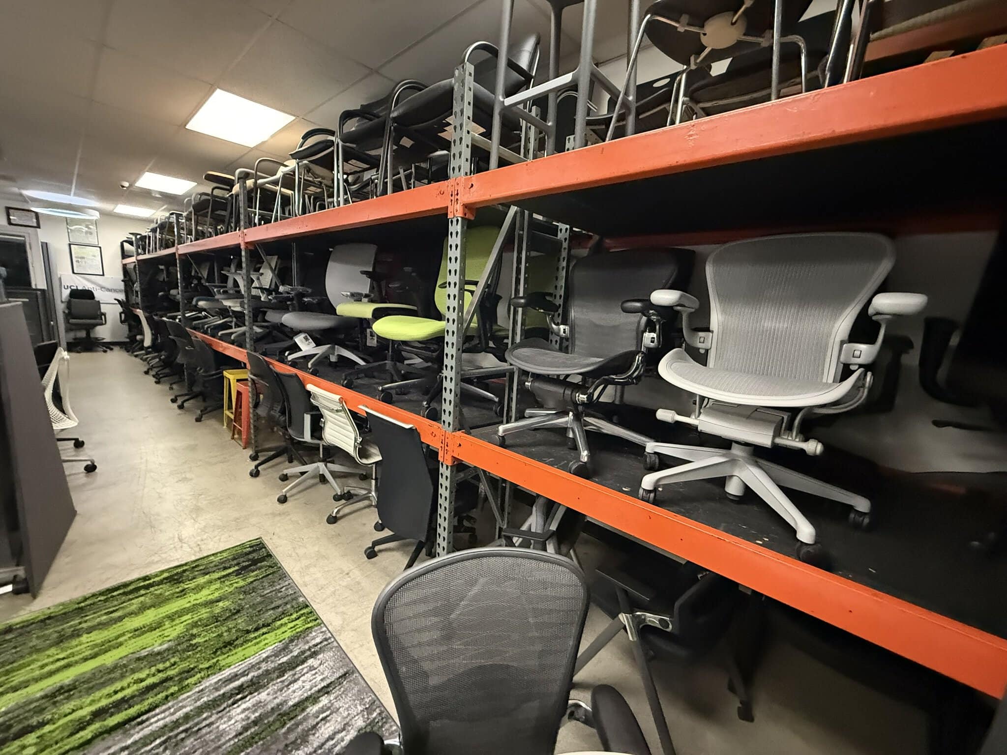 Office chairs stored on industrial shelving at Cube World USA.