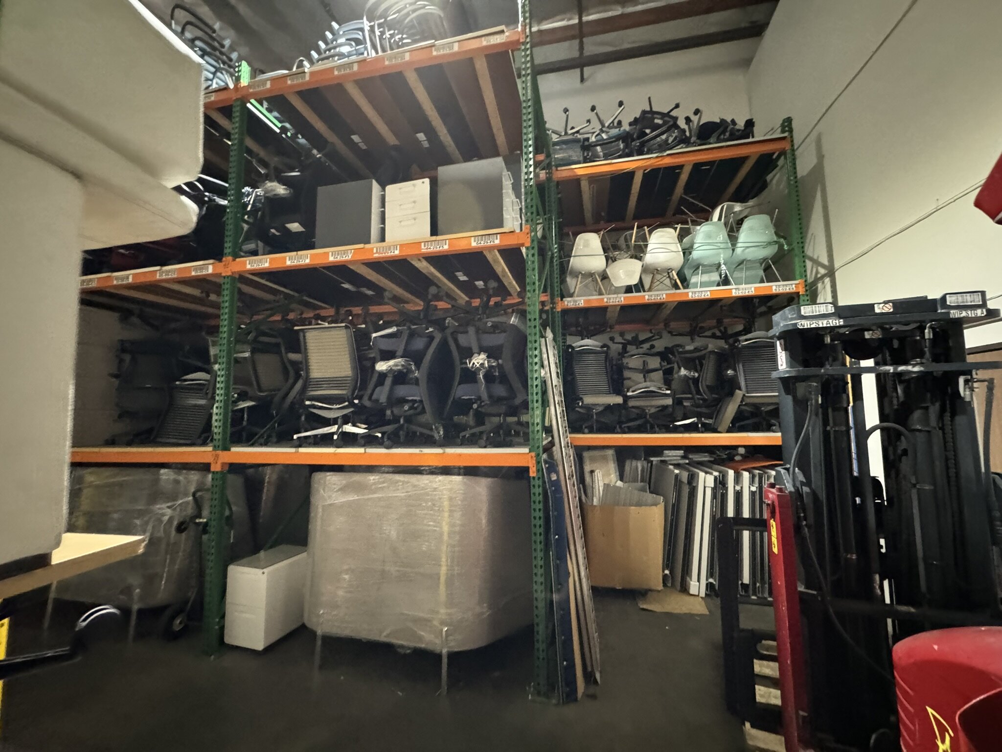 Warehouse of office furniture including chairs, desks, and accessories at Cube World USA.