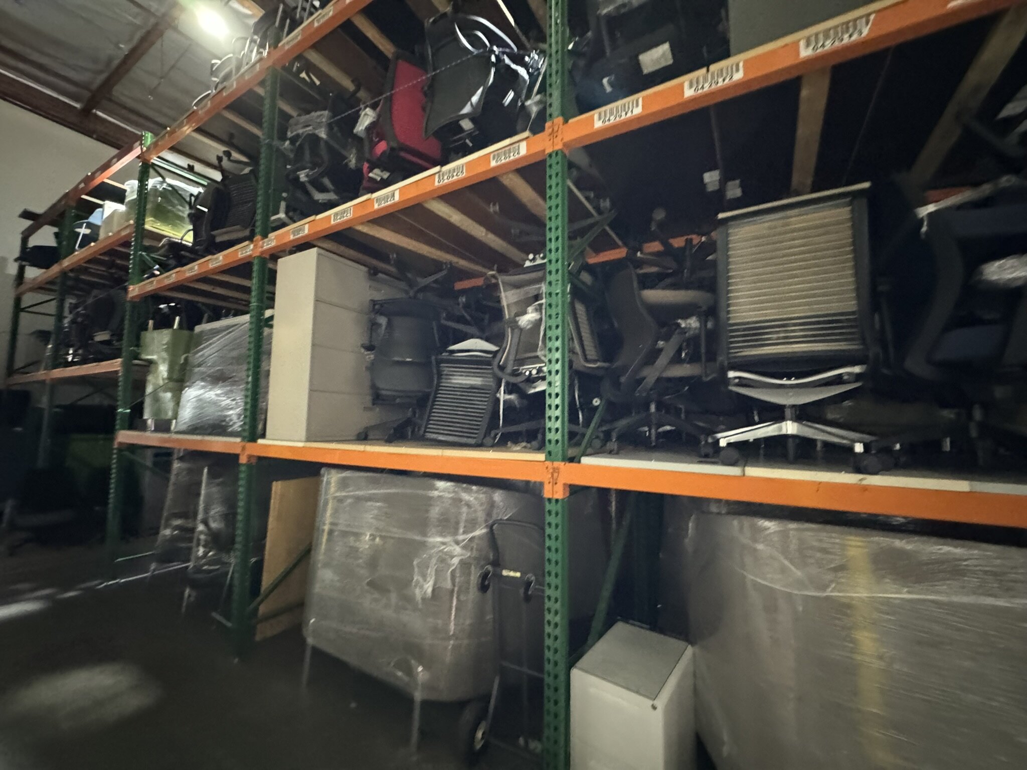 Office furniture storage shelves with chairs and desks at Cube World USA.