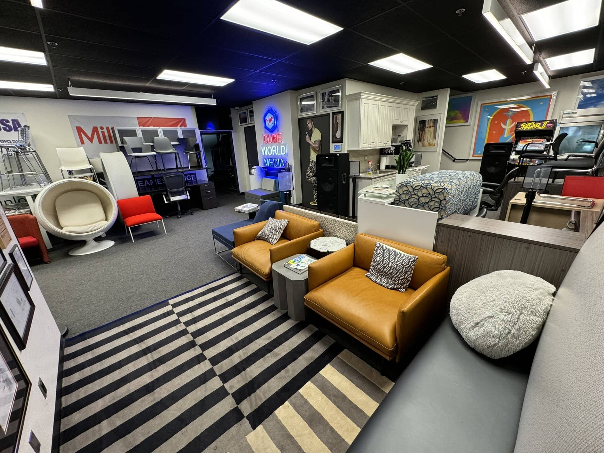 Modern office furniture display with chairs, desks, and decor at Cube World USA.