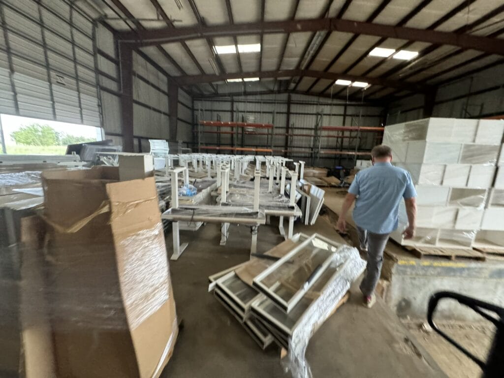 Warehouse with office furniture and packaging materials at Cube World USA.