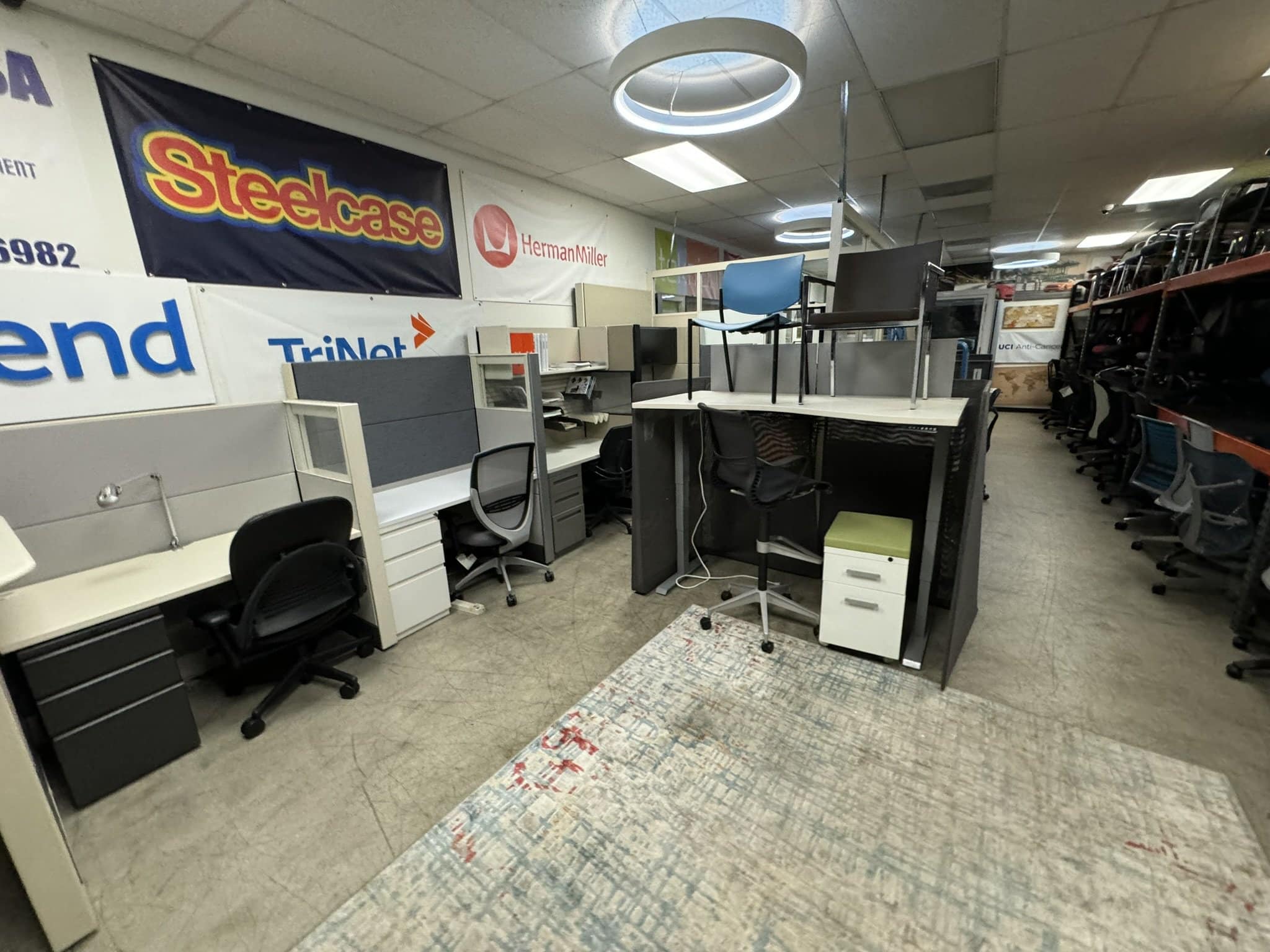 Modern office desks and chairs in Cube World USA showroom for rent or purchase.