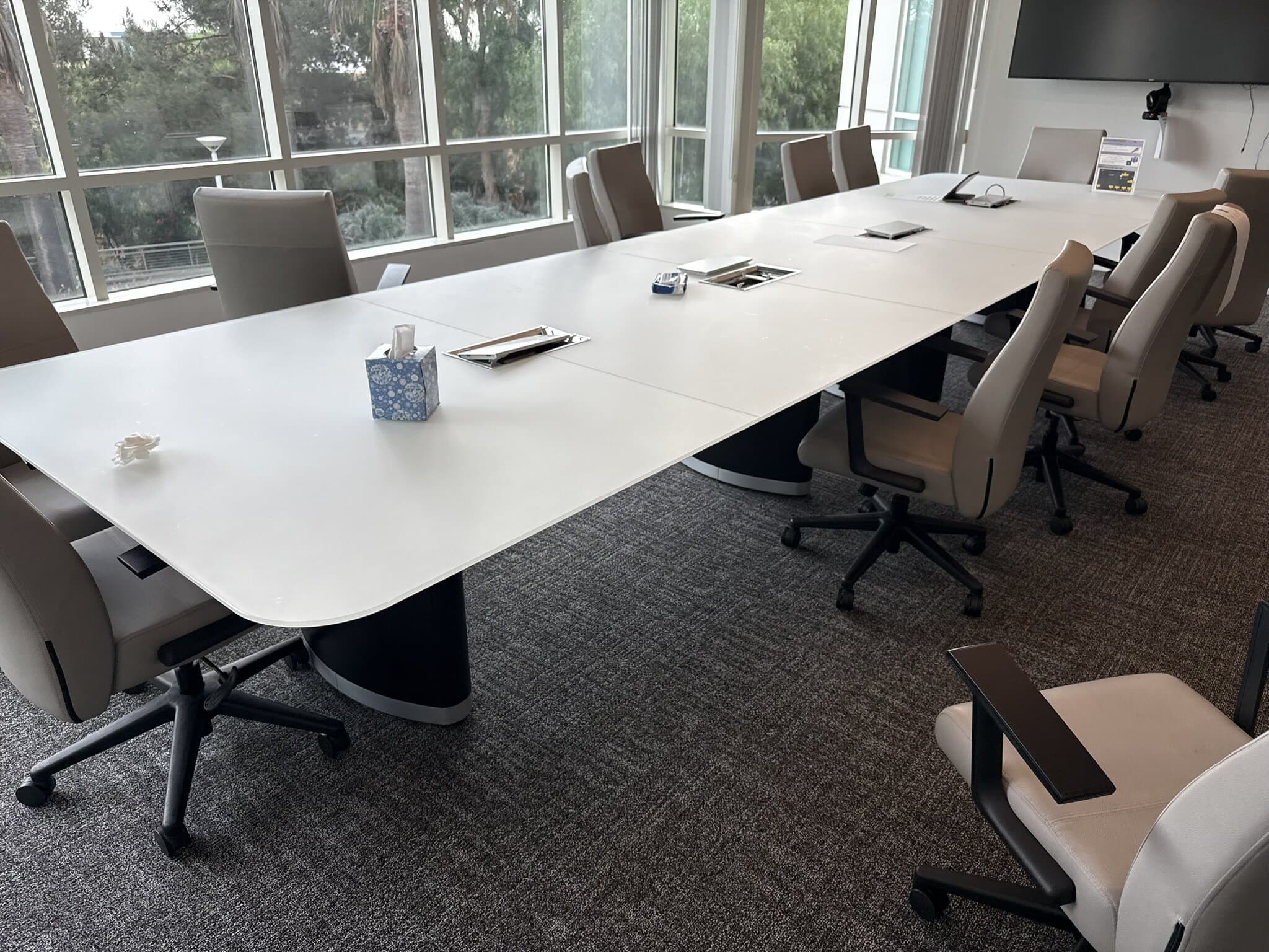 Contemporary office conference table with chairs, ideal for meetings and collaborative work.