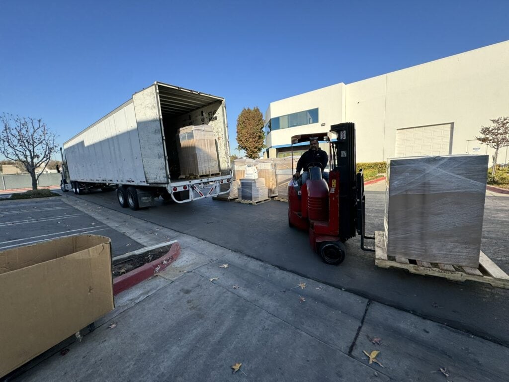 Warehouse loading with forklift and pallets at Cube World USA.