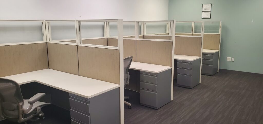 Contemporary office cubicles with desks and chairs for productive work environments.