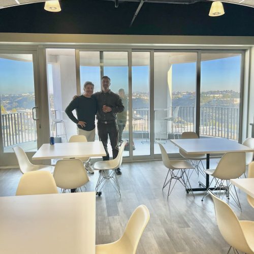 Office meeting room with large windows and cityscape background.