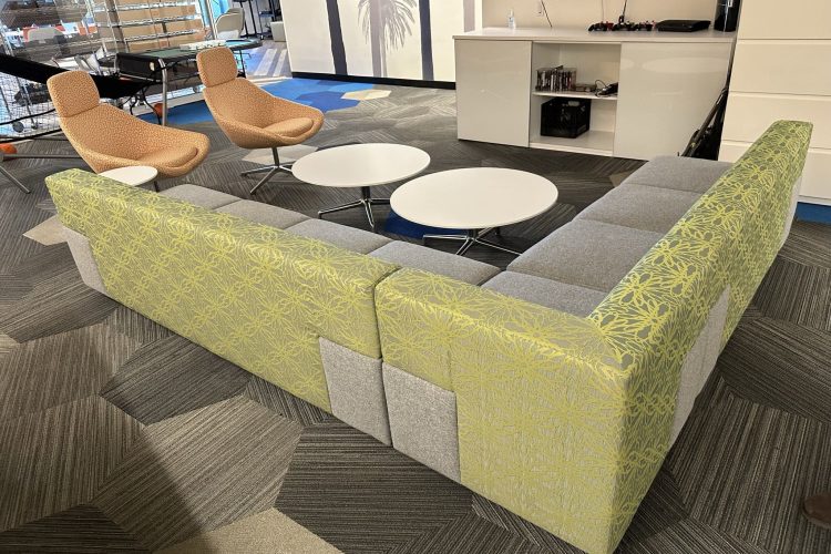 Contemporary lounge furniture with colorful chairs and round tables in a professional setting.