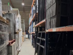 Warehouse with office furniture and equipment for rent or sale.