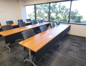 Classroom office furniture with desks and chairs in a bright, modern room.