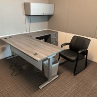 Office workspace with desk and chairs at Cube World USA.