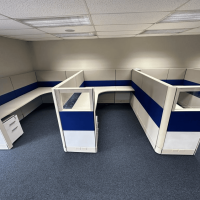 Office cubicles with blue and white panels for workspace organization.
